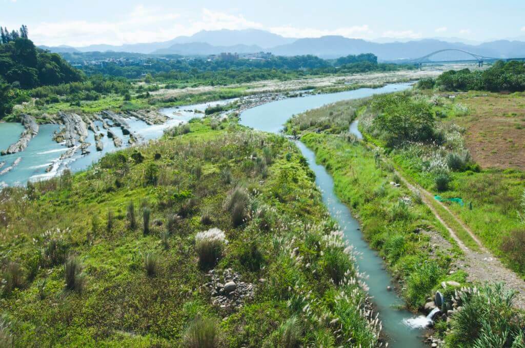 Irrigation channels and a drainage overflow ditch cut into the landscape by a river.